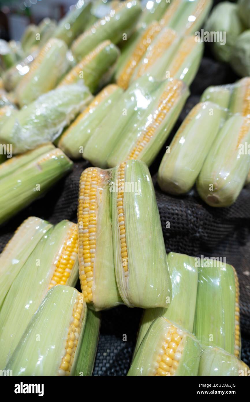 Fresh green vegetables like peas, beans, and cucumbers in a market for a healthy vegetarian diet Stock Photo