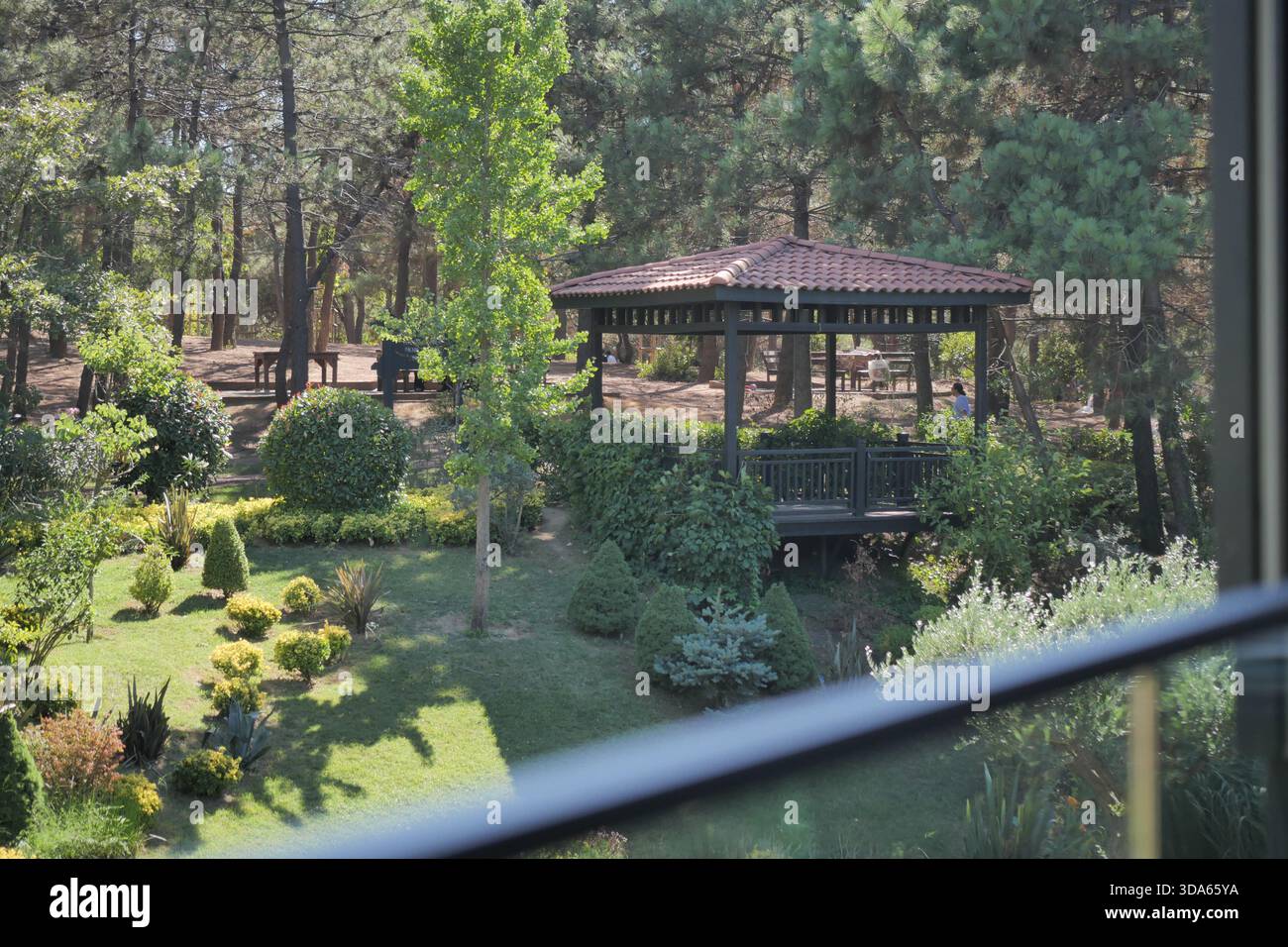 View of a garden and gazebo in a wooded area Stock Photo