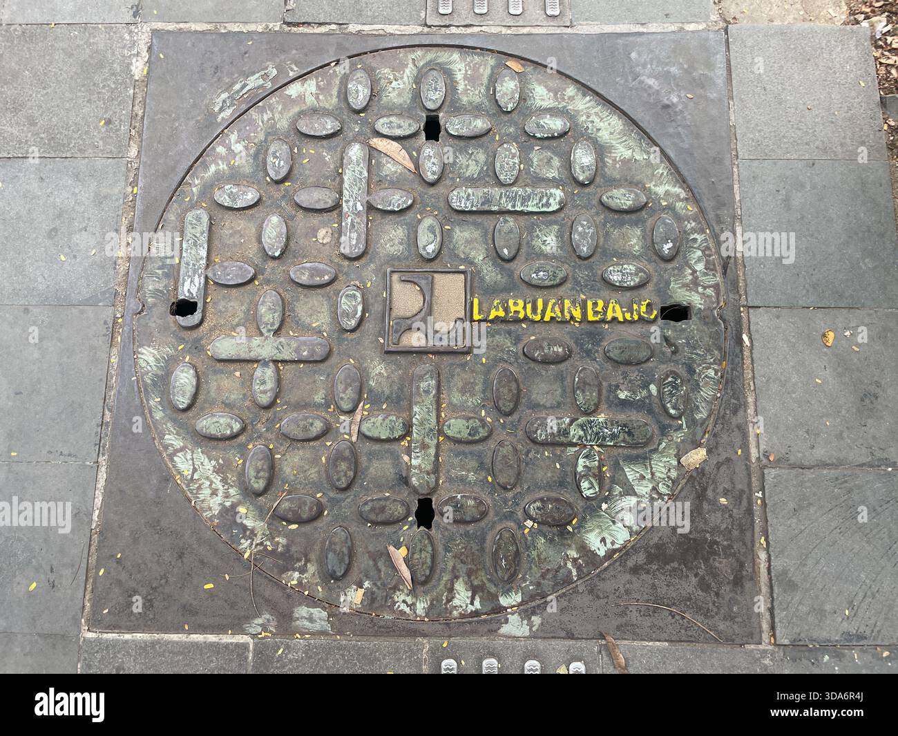 manhole cover with the logo and name of Labuan Bajo, Labuan Bajo, Indonesia - Smartphone Captured Stock Image
