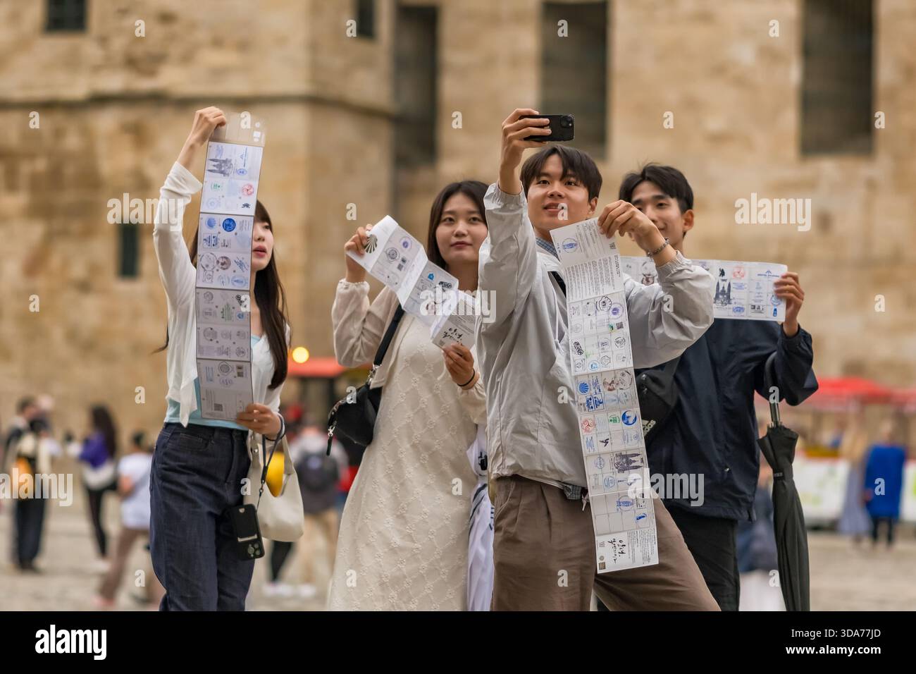 Pilgrims Taking Selfies at Cathedral of Santiago de Compostela Spain Stock Photo