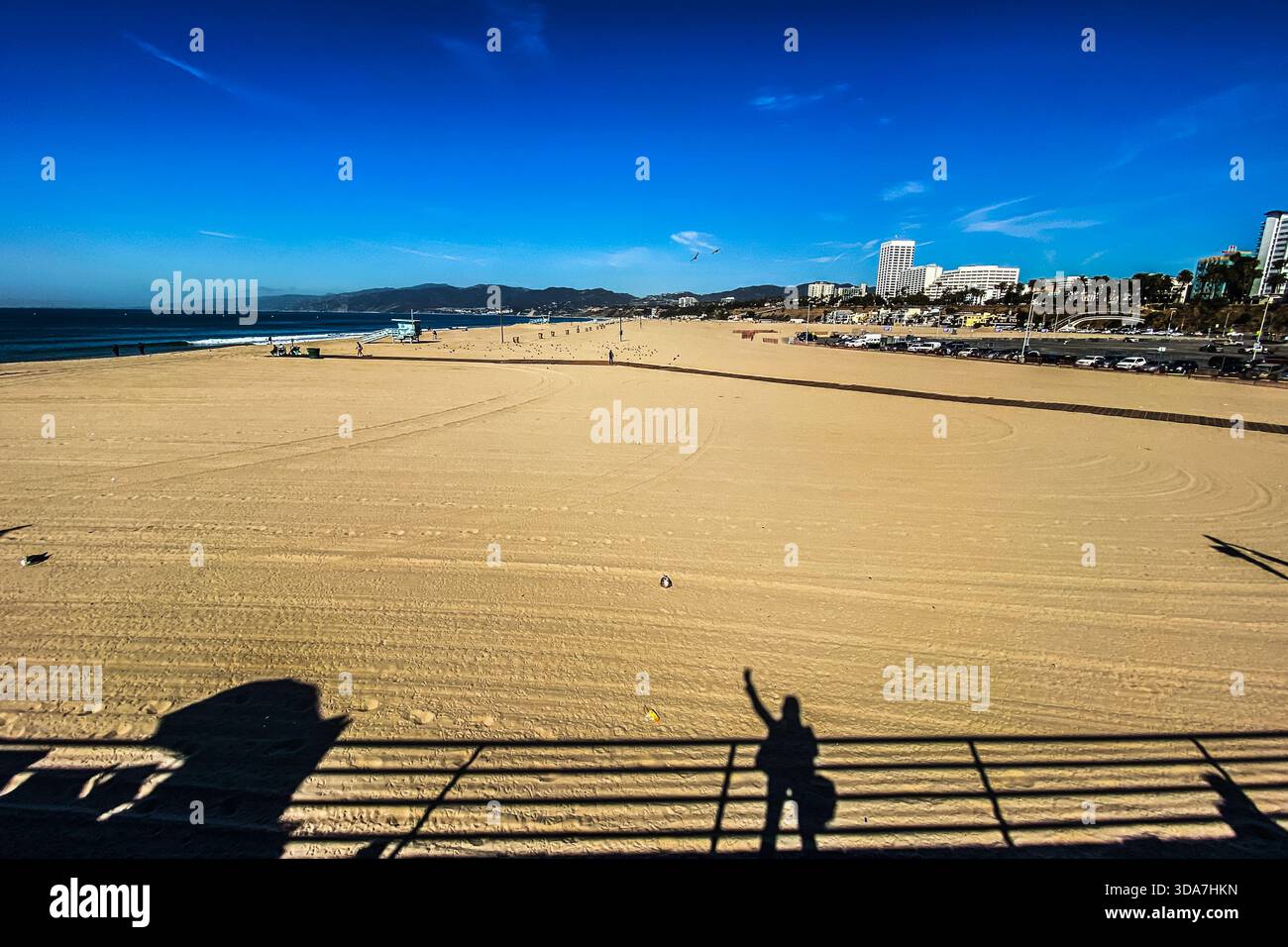 Santa Monica beach - with the photographers shadow (standing on the pier) cast in the lower side - Smartphone Captured Stock Image