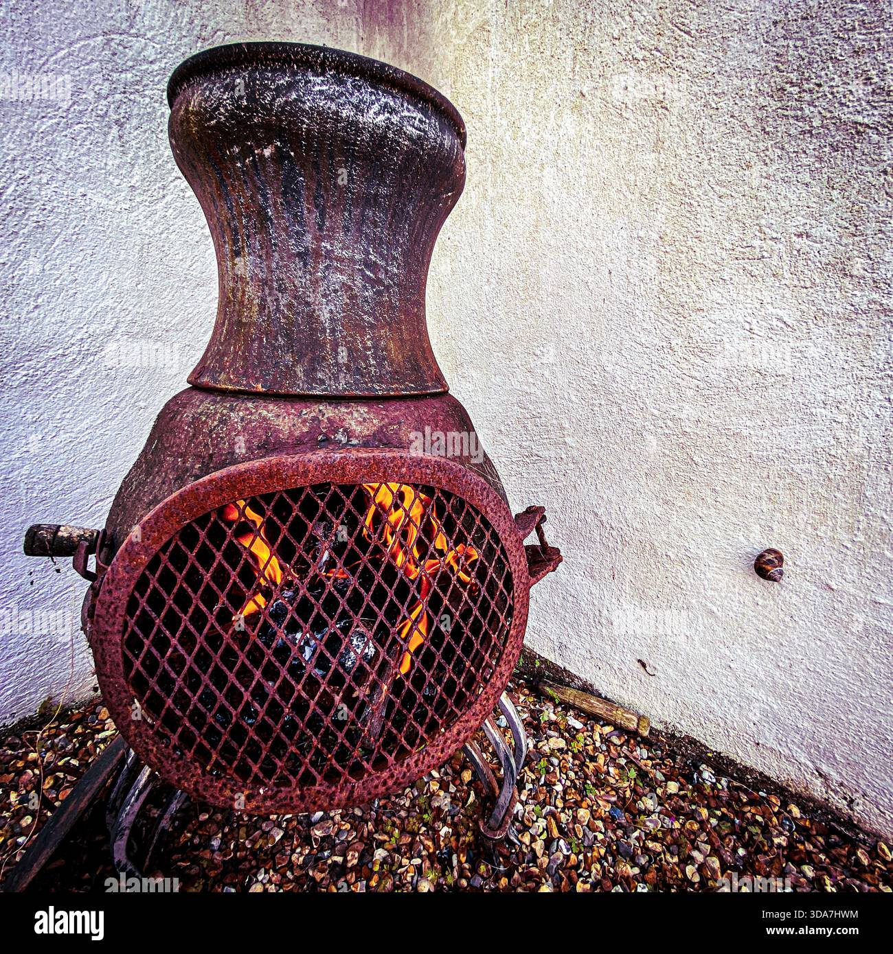 A Chimineas burning in a garden - Smartphone Captured Stock Image