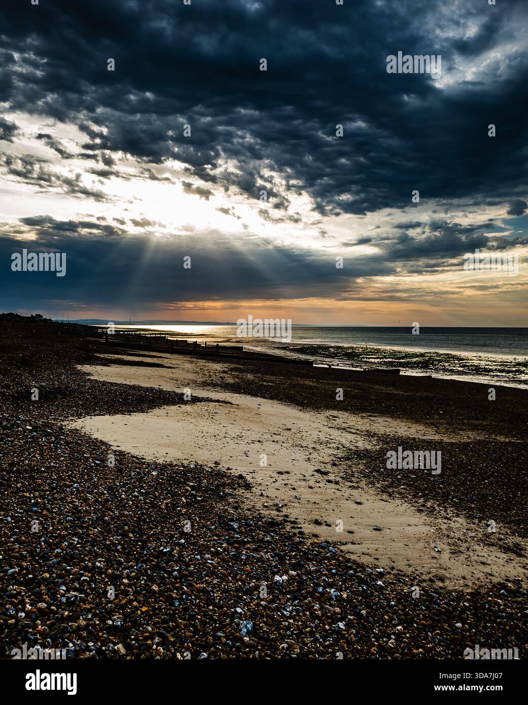 Dark and brooding beach and clouds at sunrise - Smartphone Captured Stock Image