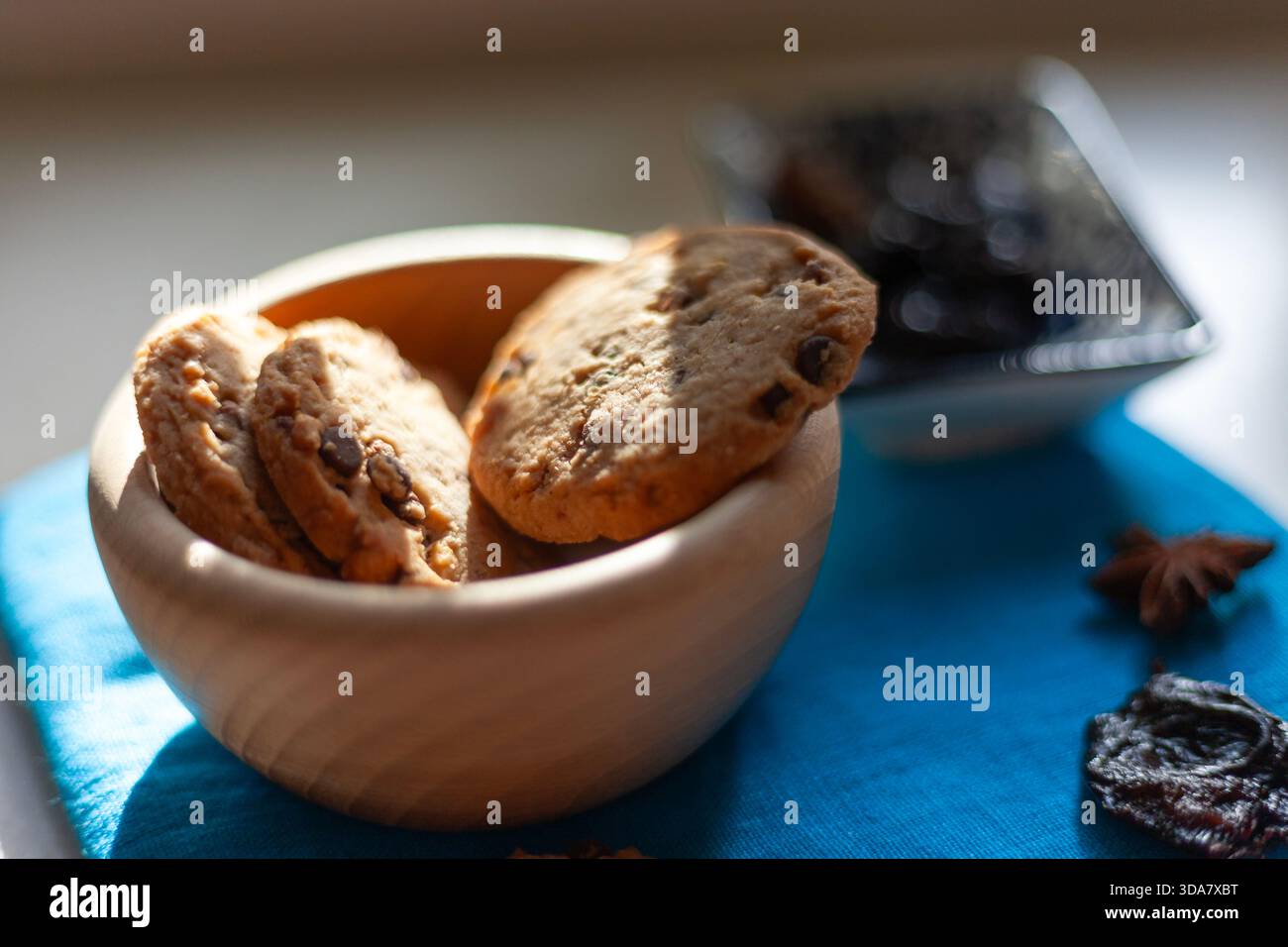 Fresh chocolate chip cookies in a wooden bowl Stock Photo