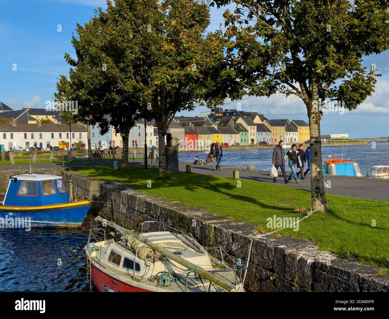A brisk Autumn sunny day in Galway horbour, Ireland , looking towards The Long Walk across the water - Smartphone Captured Stock Image