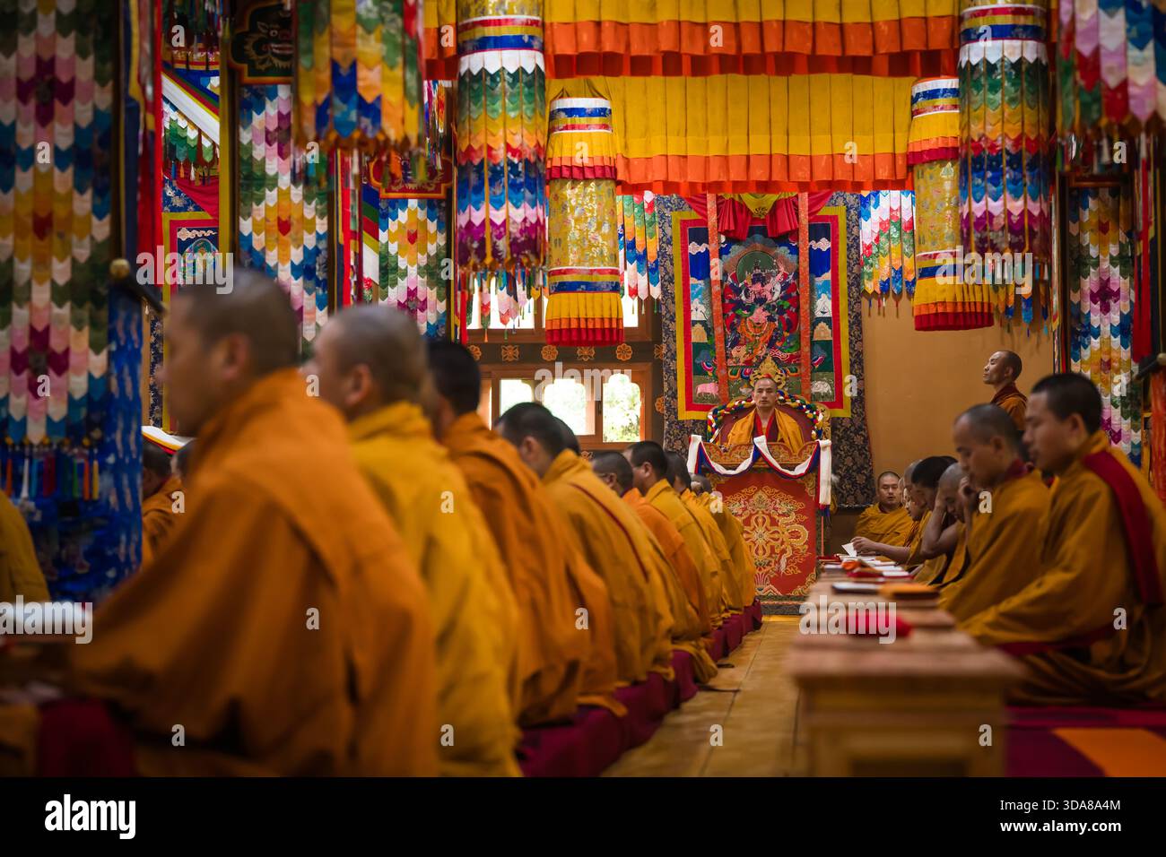 Paro Inside Paro, Bhutan - 17 September 2025: View of monks in orange robes seated ...
