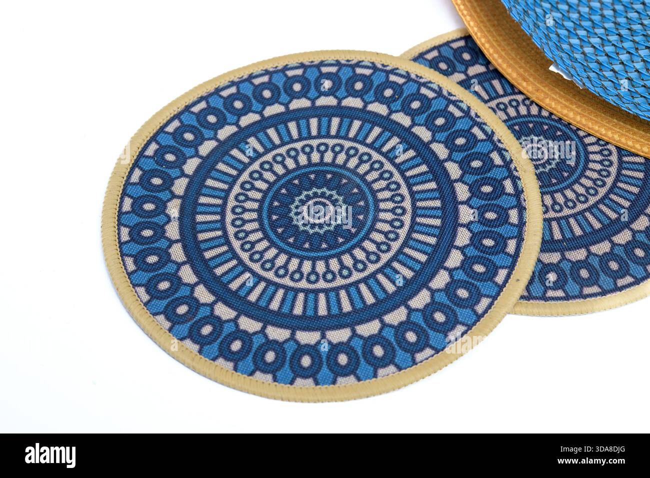Blue circular placemats with geometric pattern on a white background. Stock Photo