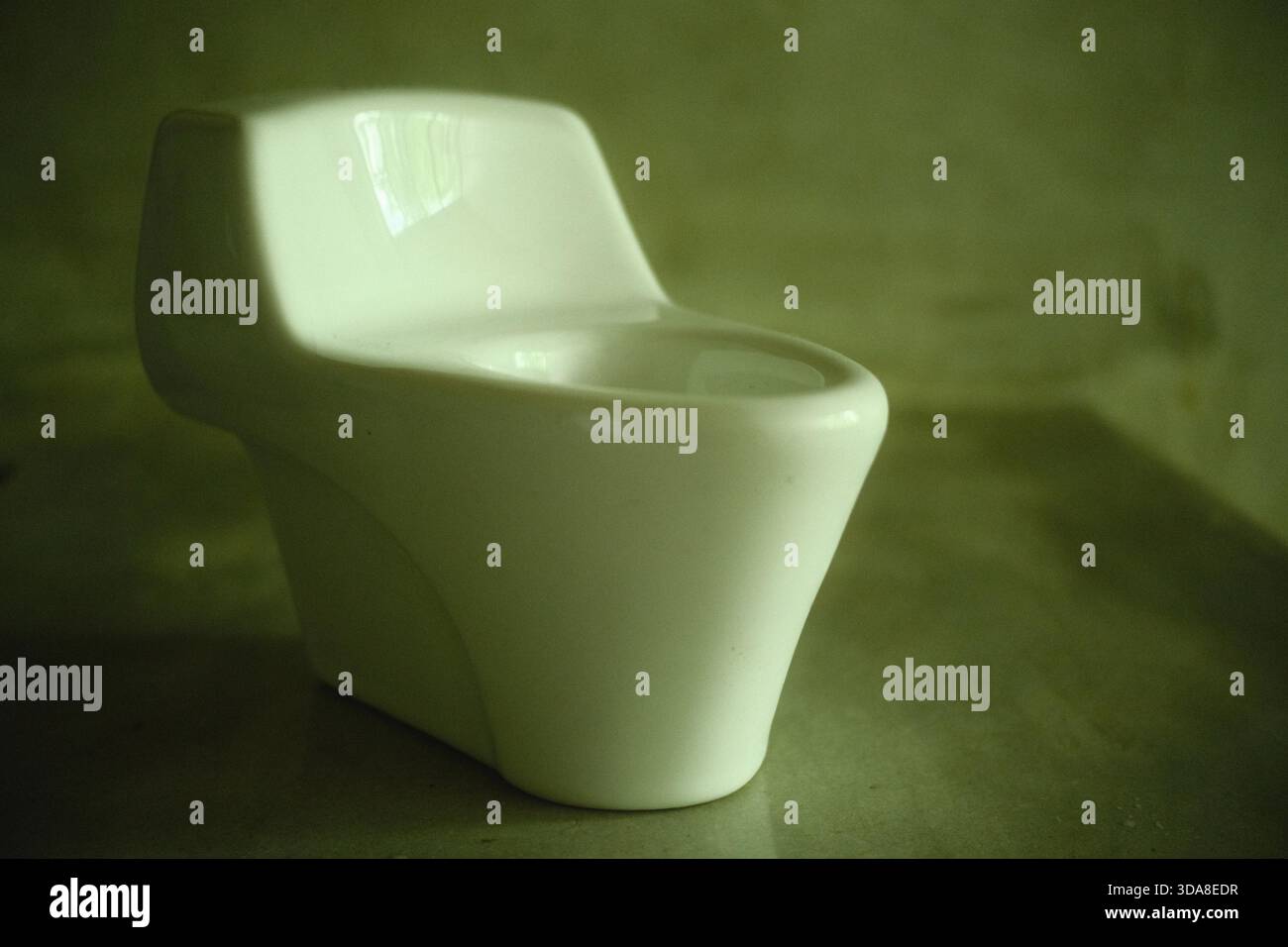 Miniature One-Piece Toilet Model on Display Stock Photo