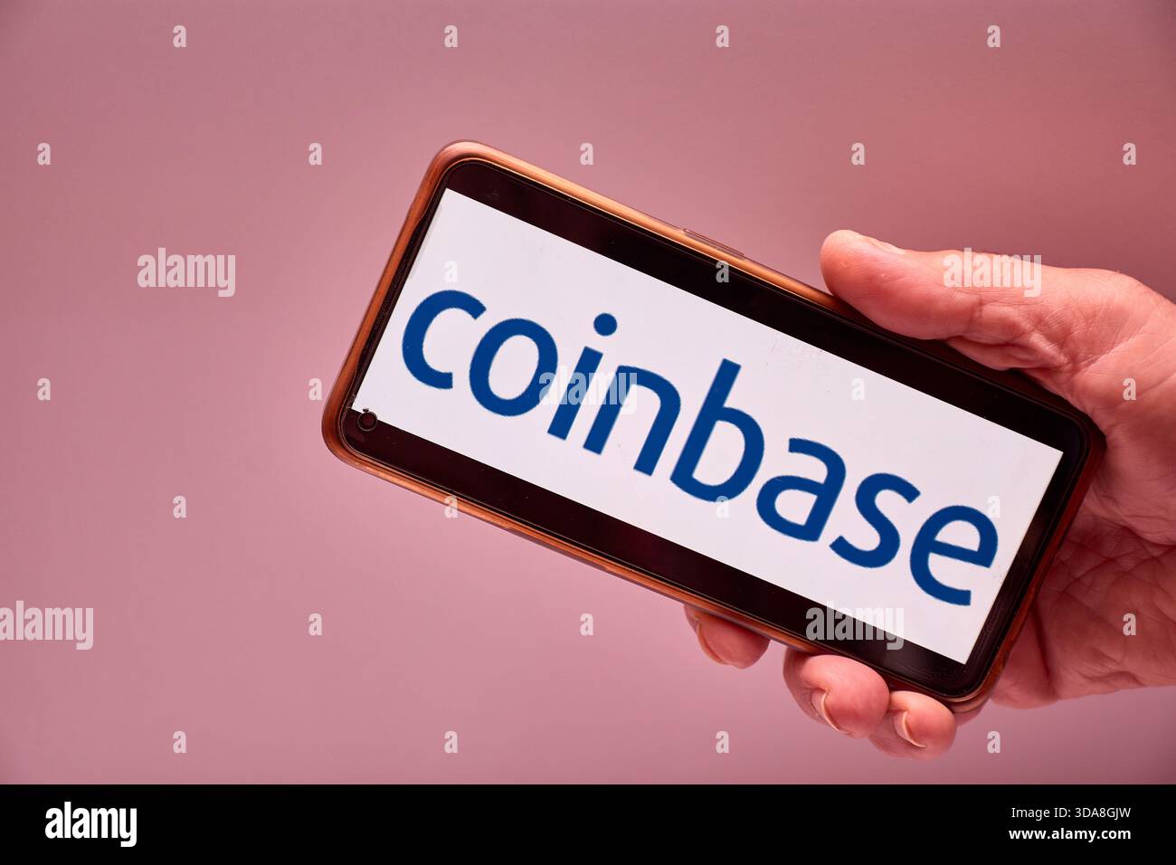 Vigo, Spain, November 30, 2025.A human hand holds a smartphone whose screen  displays the logo of Coinbase, a US-based cryptocurrency trading and inves  Stock Photo - Alamy