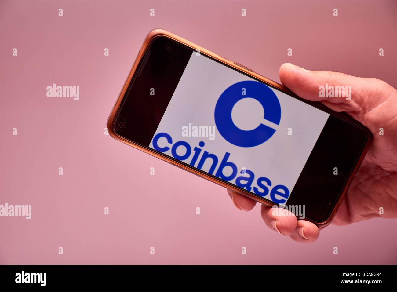 Vigo, Spain, November 30, 2025.A human hand holds a smartphone whose screen  displays the logo of Coinbase, a US-based cryptocurrency trading and inves  Stock Photo - Alamy