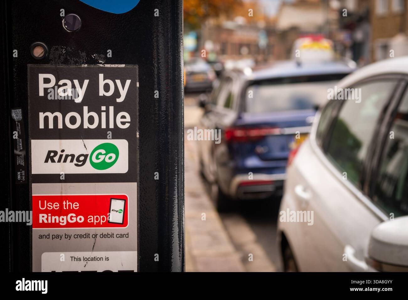 LONDON - NOVEMBER 7, 2025: RingGo Mobile Parking Payment Meter �C Pay by App Signage with QR Code and Location ID in Busy Street Stock Photo