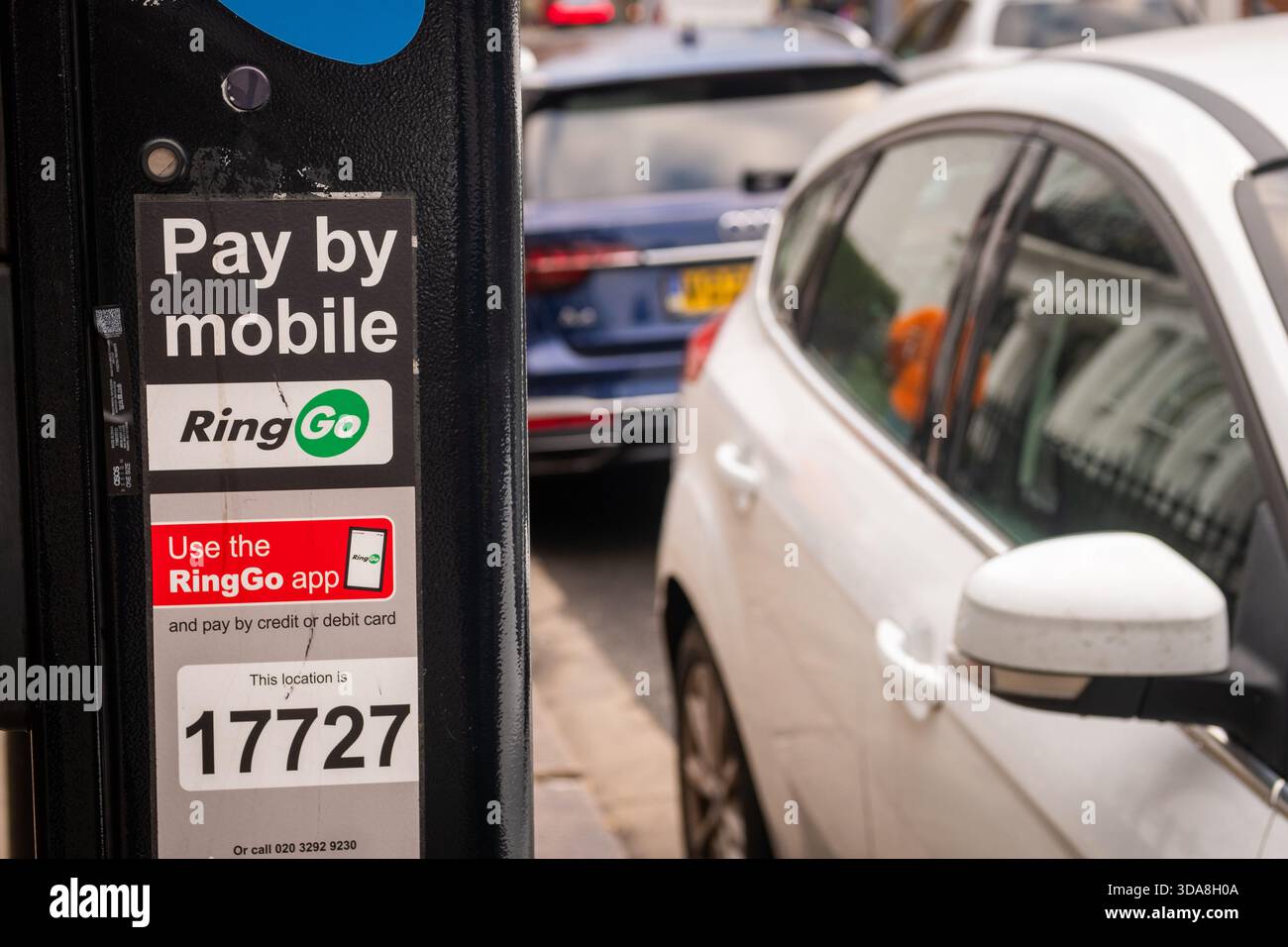 LONDON - NOVEMBER 7, 2025: RingGo Mobile Parking Payment Meter �C Pay by App Signage with QR Code and Location ID in Busy Street Stock Photo