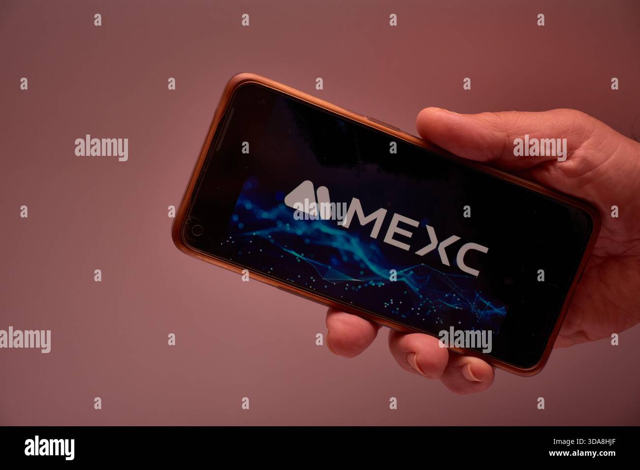 Vigo, Spain, November 30, 2025.A human hand holds a smartphone whose screen  displays the MEXC logo, a cryptocurrency exchange platform renowned for it  Stock Photo - Alamy