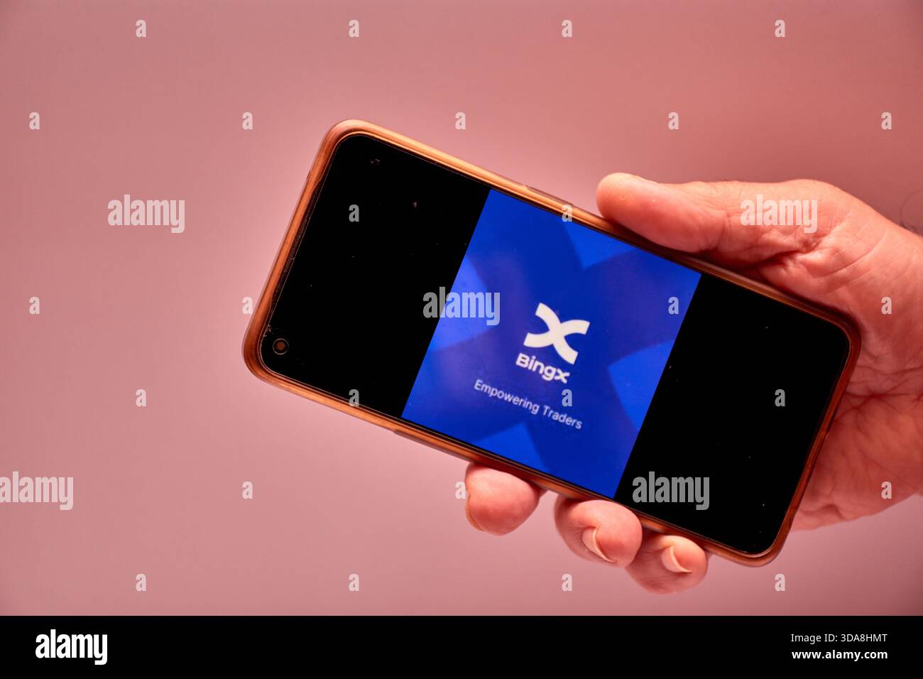Vigo, Spain, November 30, 2025.A human hand holds a smartphone whose screen  displays the BingX logo, an international cryptocurrency exchange platform  Stock Photo - Alamy