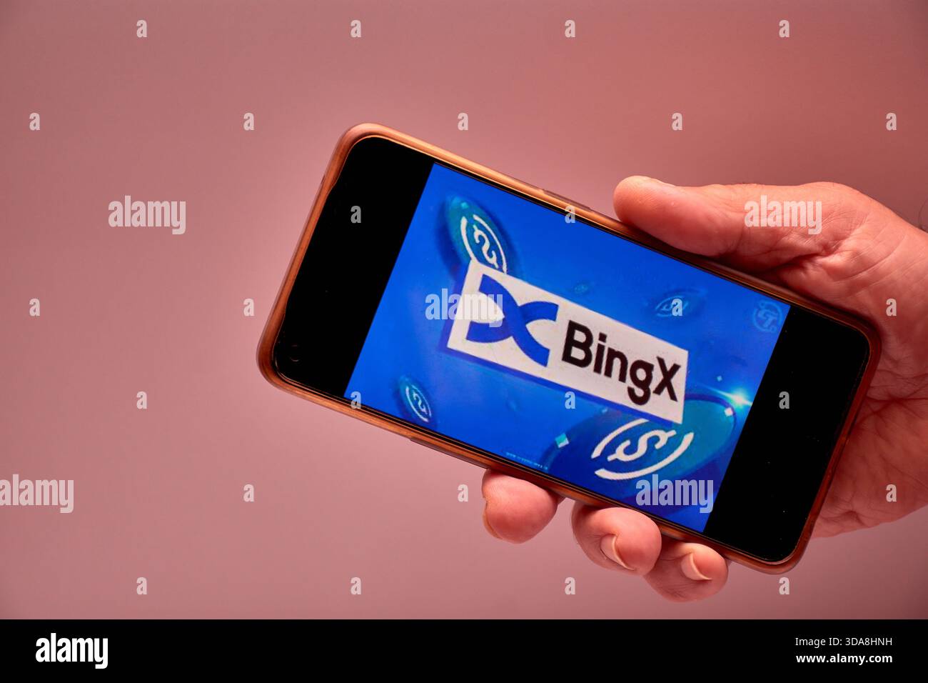 Vigo, Spain, November 30, 2025.A human hand holds a smartphone whose screen  displays the BingX logo, an international cryptocurrency exchange platform  Stock Photo - Alamy