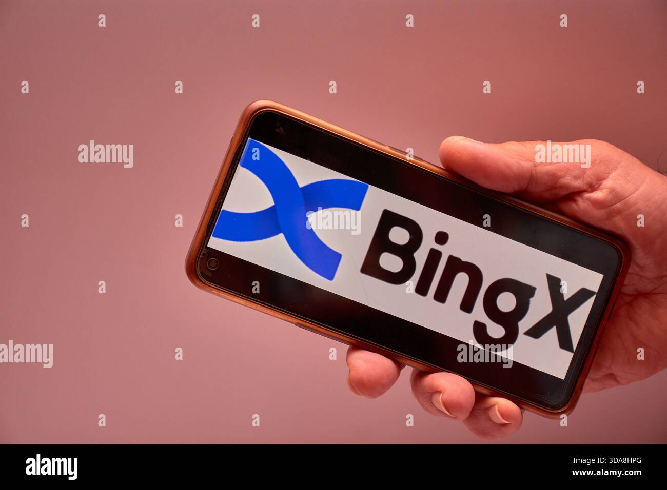 Vigo, Spain, November 30, 2025.A human hand holds a smartphone whose screen  displays the BingX logo, an international cryptocurrency exchange platform  Stock Photo - Alamy