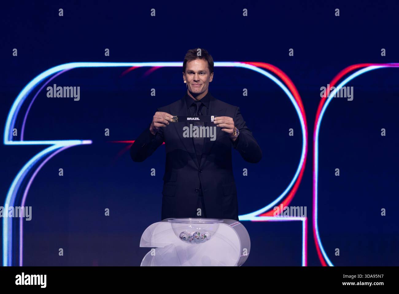 Draw assistant Tom Brady draws out the card of Brazil during the FIFA ...