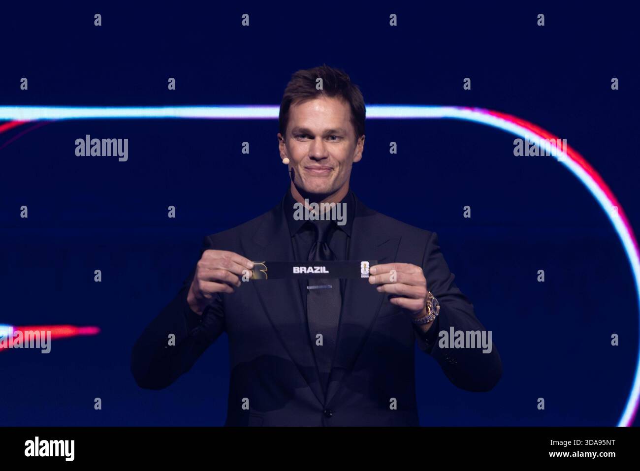 Draw assistant Tom Brady draws out the card of Brazil during the FIFA ...