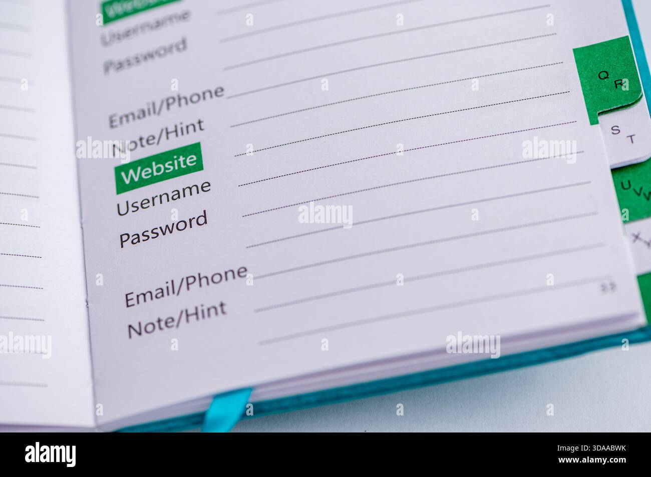 A notebook page shows fields for website, username, and password. Stock Photo