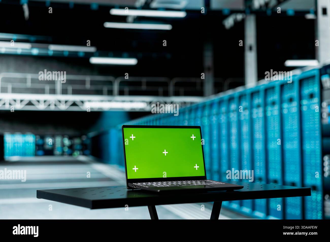 Green screen laptop overseeing data center hardware driving automation ...