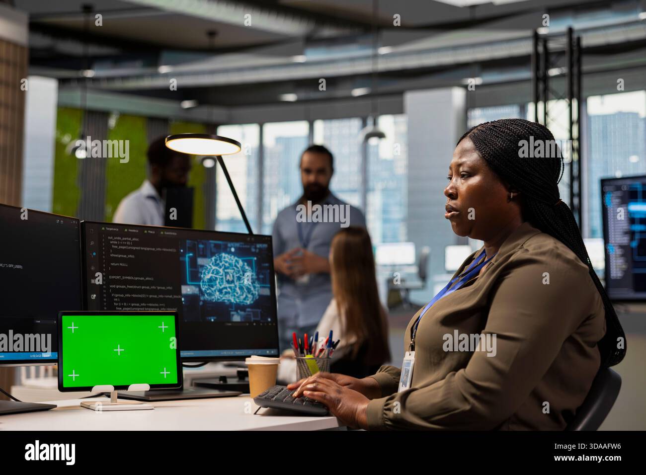 Admin writing code snippets on chroma key tablet in modern office ...