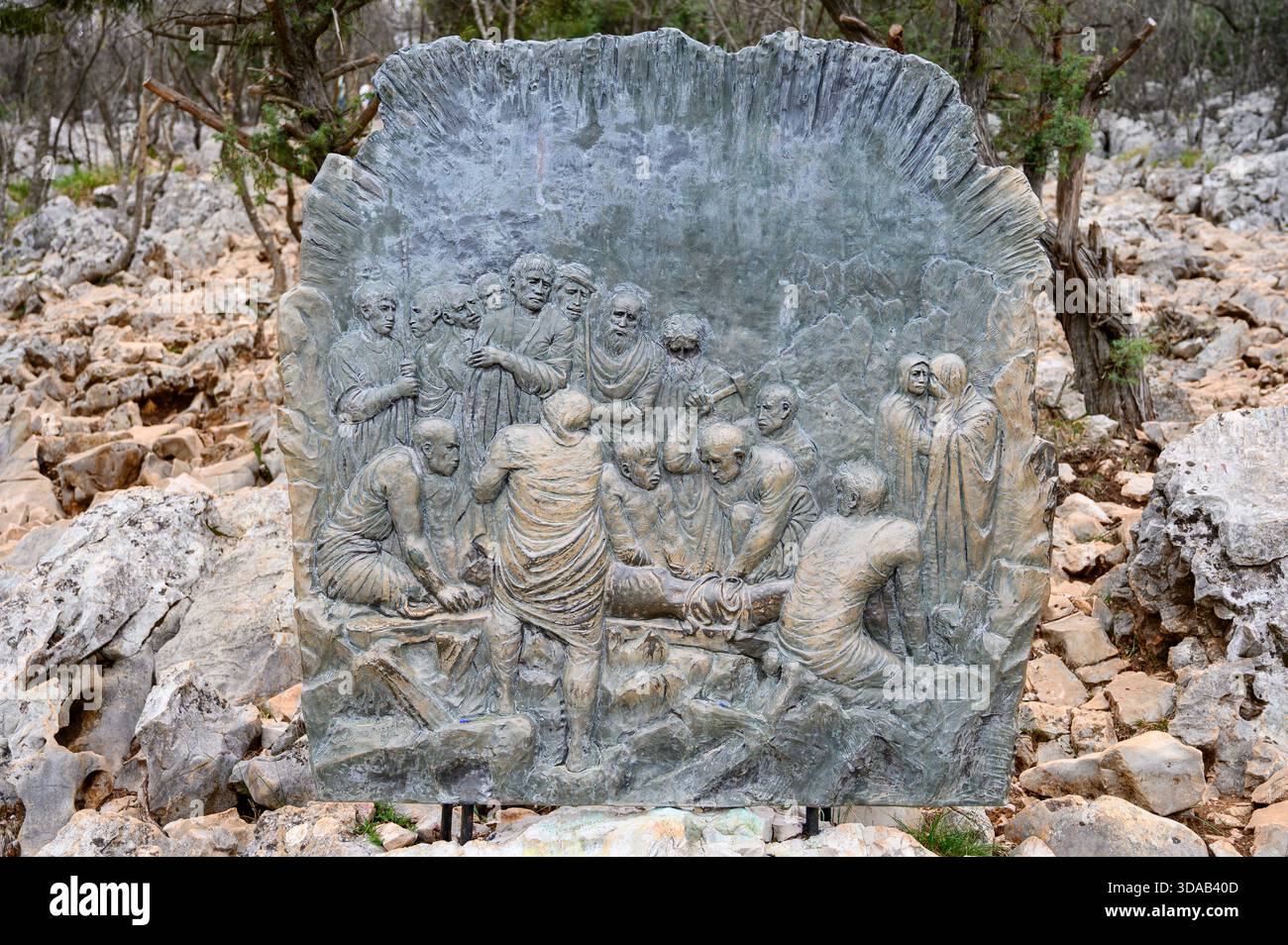 Station XI: Jesus is nailed to the Cross. The Way of the Cross on Mount Križevac (the Cross Mountain) in Medjugorje. - Stock Image