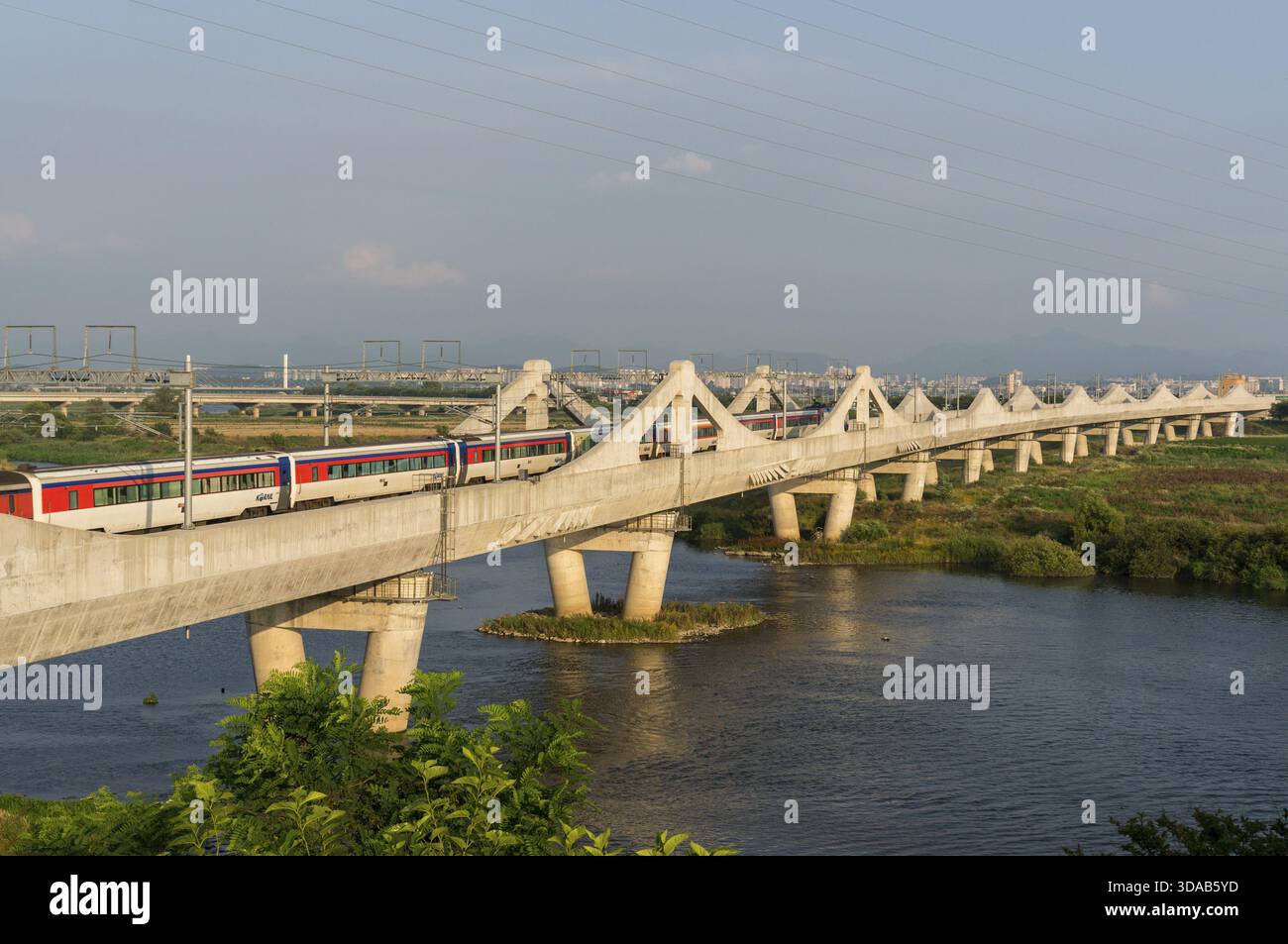 Korean locomotive on a concrete bridge over a river, Jeonju, South ...