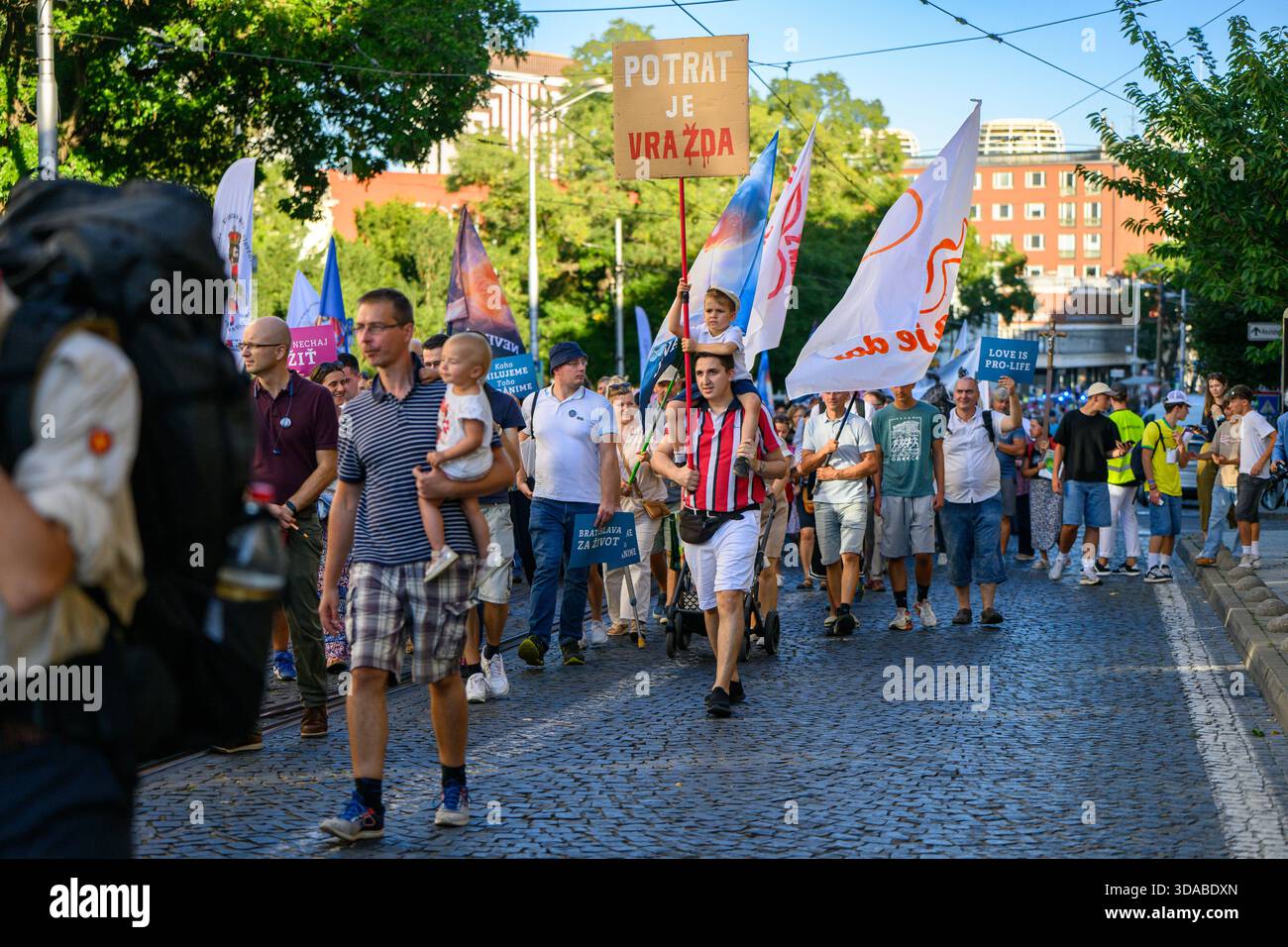 March for Life procession moving through the streets of Bratislava, Slovakia. 'Potrat je vražda' [Abortion is murder] - Stock Image