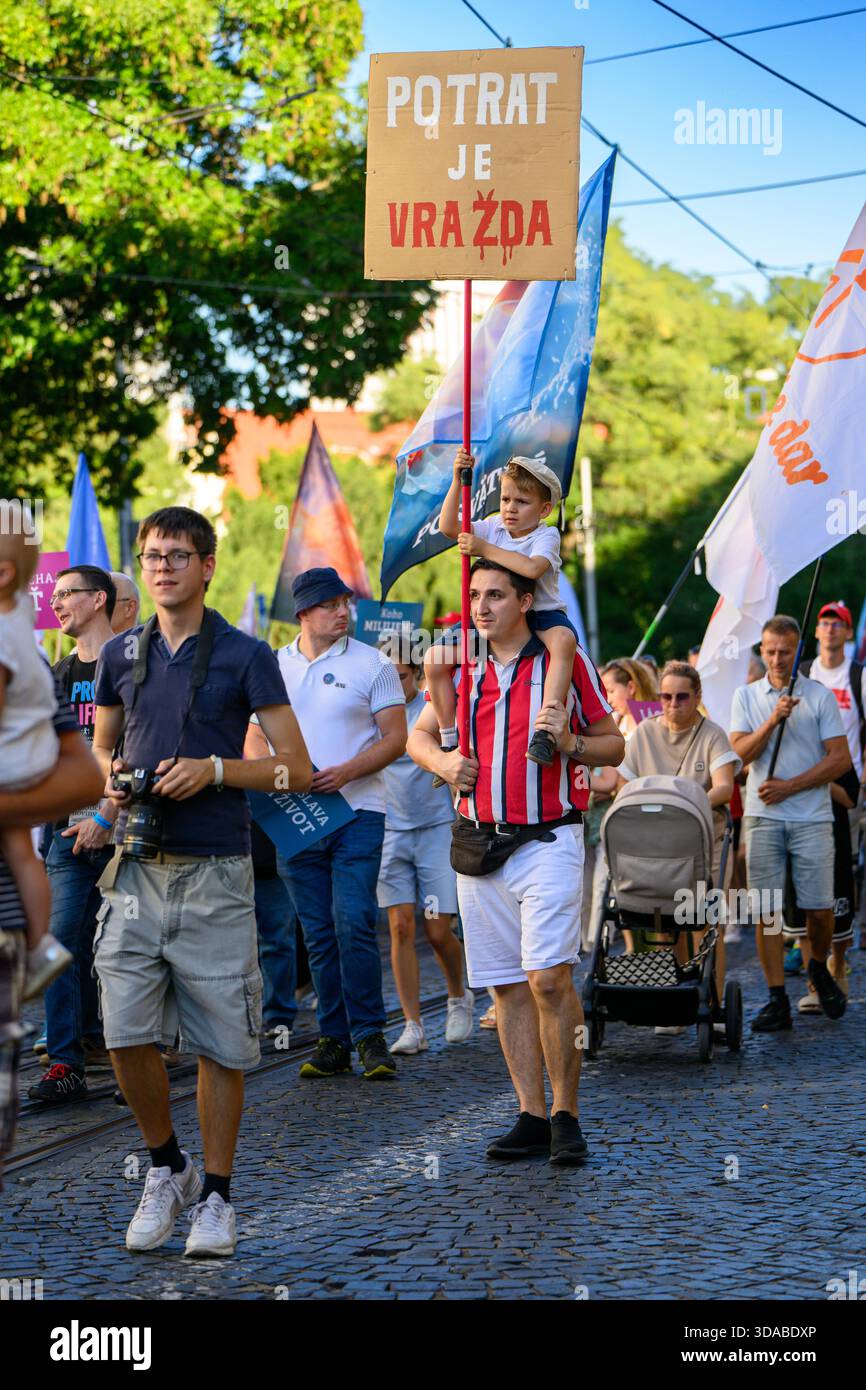 March for Life procession moving through the streets of Bratislava, Slovakia. 'Potrat je vražda' [Abortion is murder] - Stock Image