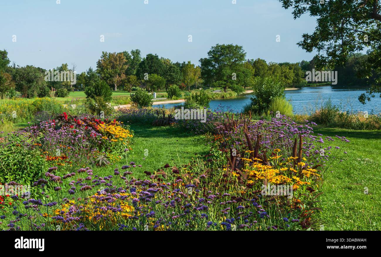 A flower garden blooming by Grasmere Lake at Washington Park in Denver, Colorado. Stock Photo