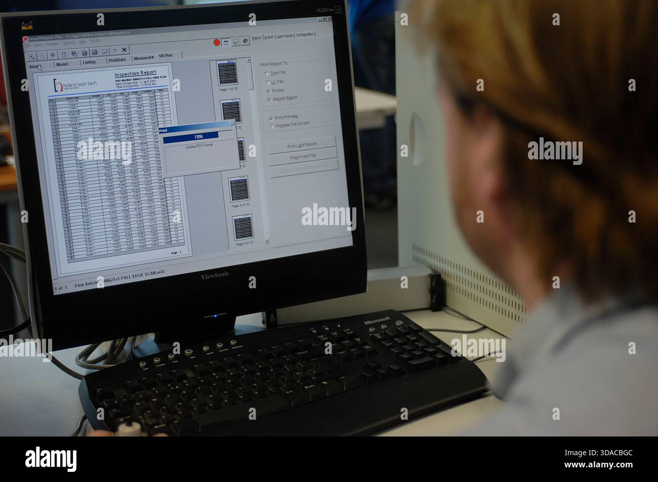 Workers guiding a computed guided lathe in an engineering factory. Stock Photo