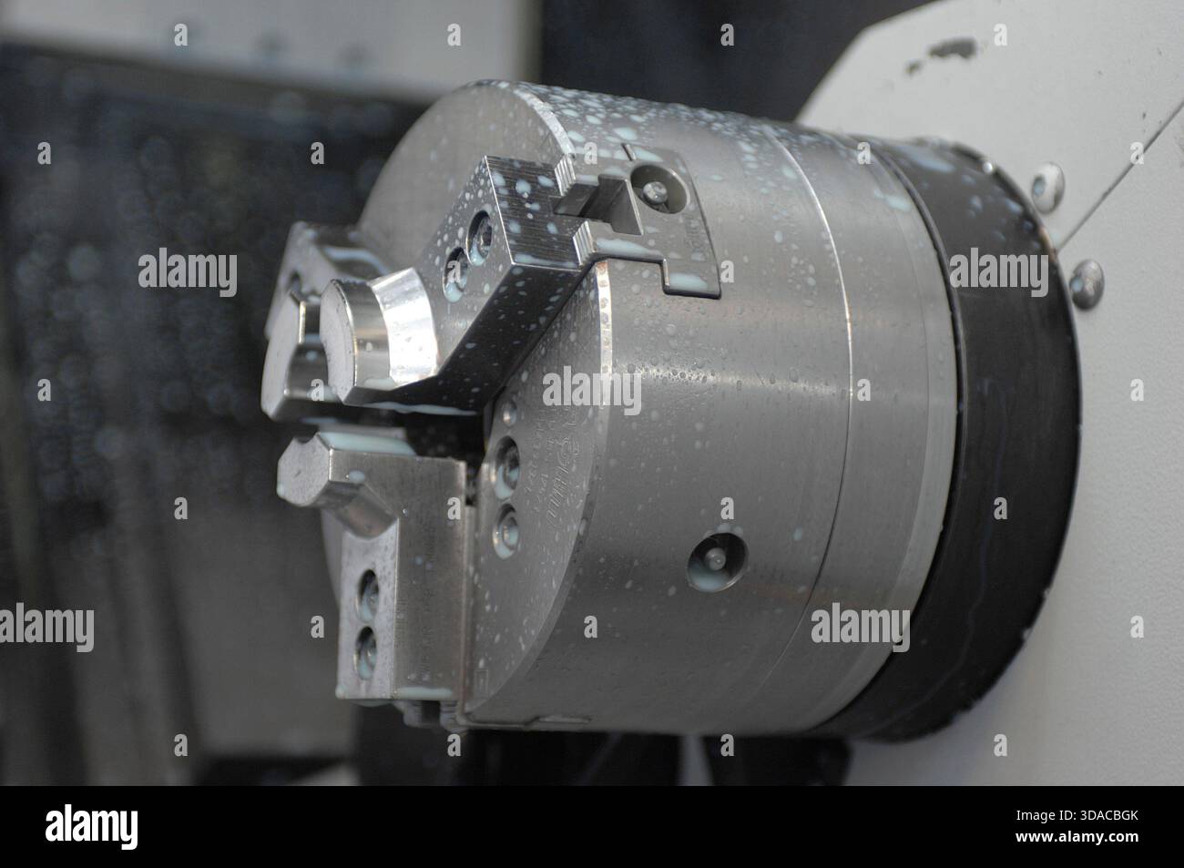 Workers guiding a computed guided lathe in an engineering factory. Stock Photo