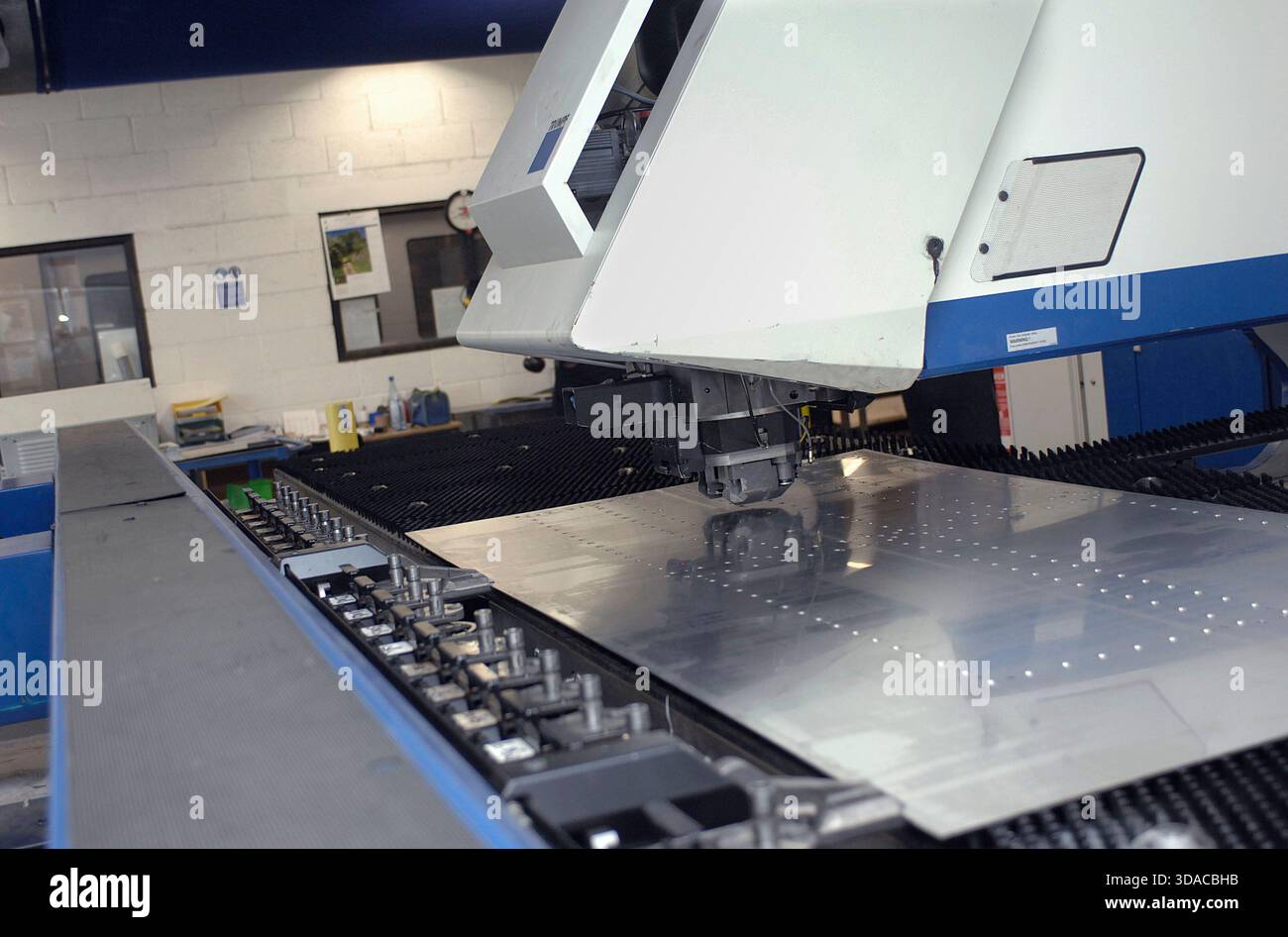 Workers guiding a computed guided lathe in an engineering factory. Stock Photo