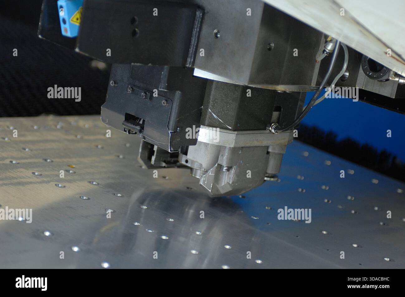 Workers guiding a computed guided lathe in an engineering factory. Stock Photo