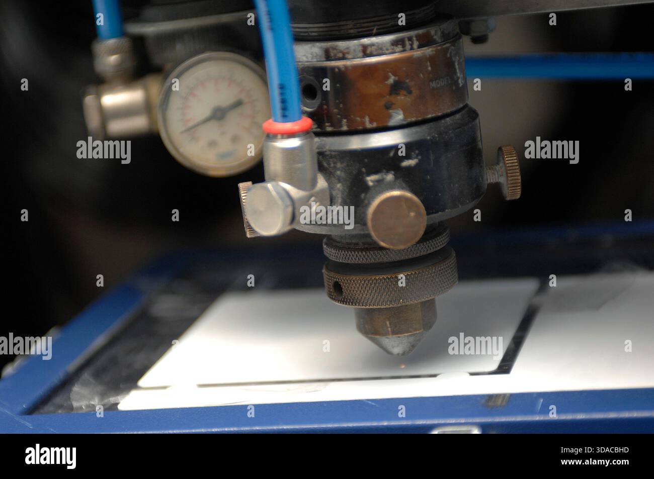 Workers guiding a computed guided lathe in an engineering factory. Stock Photo