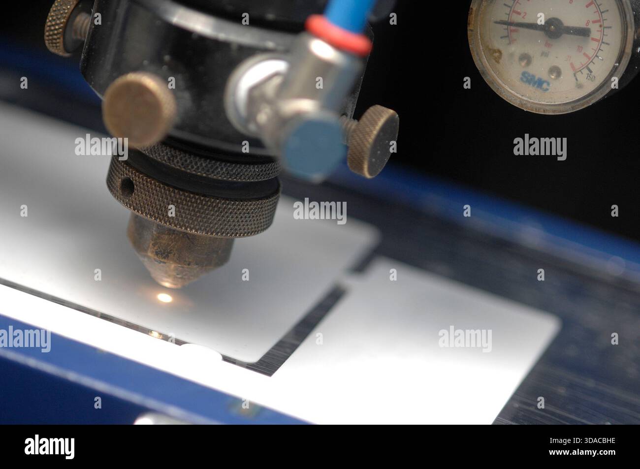 Workers guiding a computed guided lathe in an engineering factory. Stock Photo