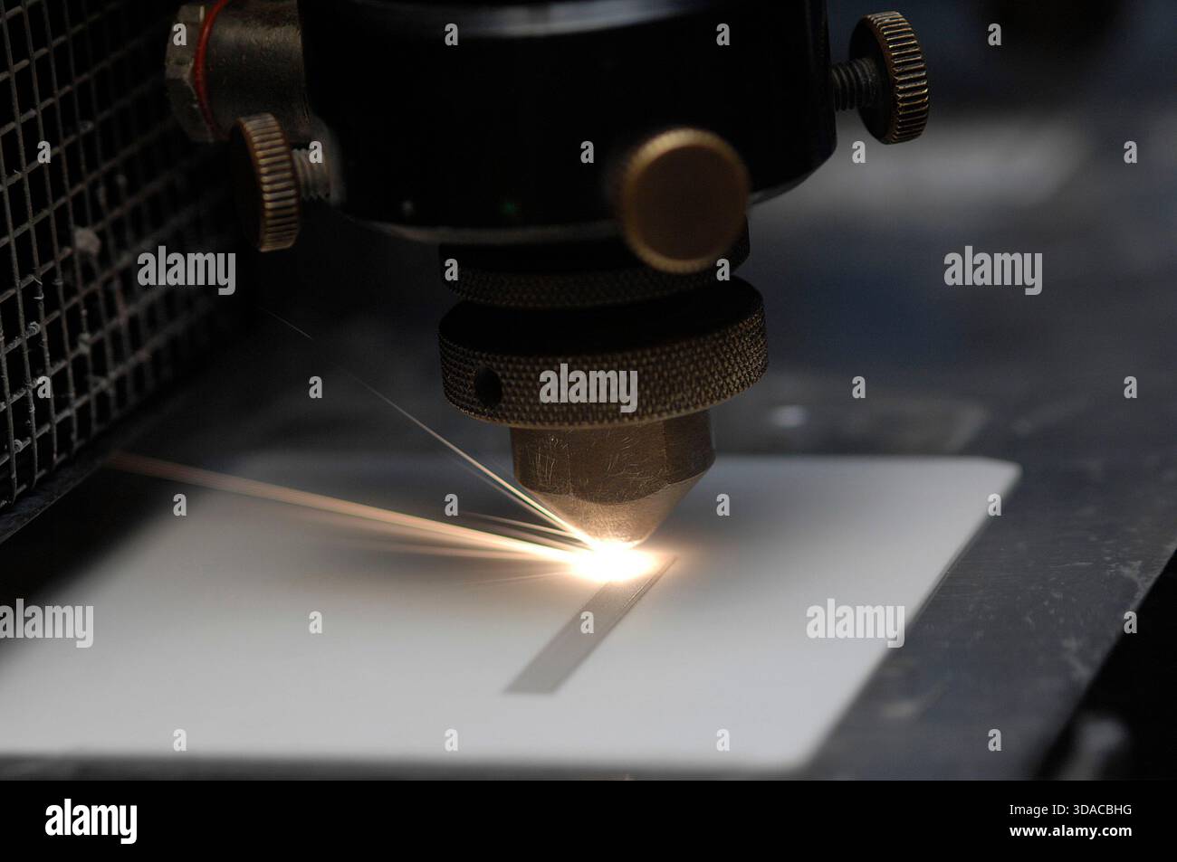 Workers guiding a computed guided lathe in an engineering factory. Stock Photo