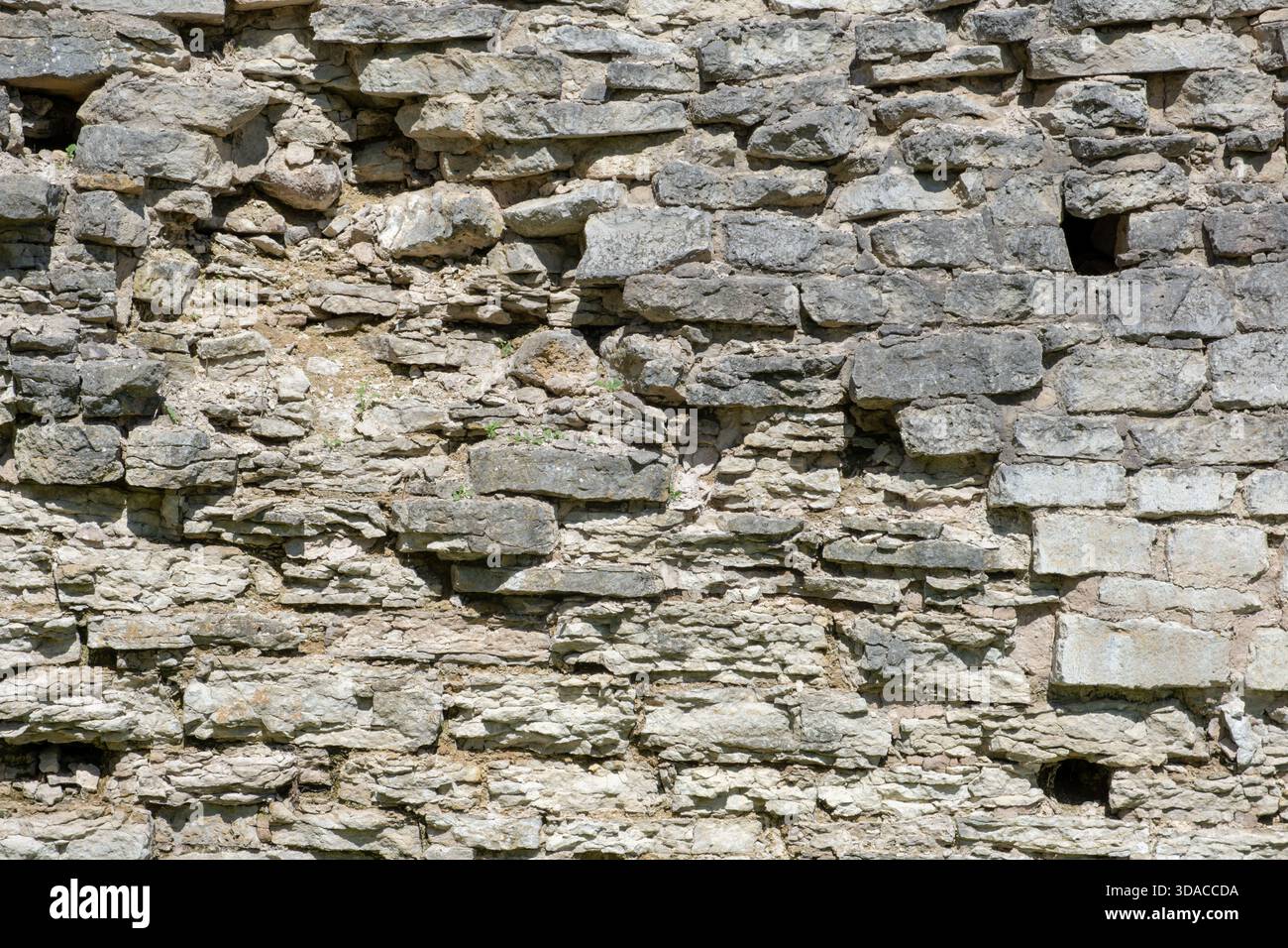 Weathered Stone Wall with Uneven Rocks Stock Photo