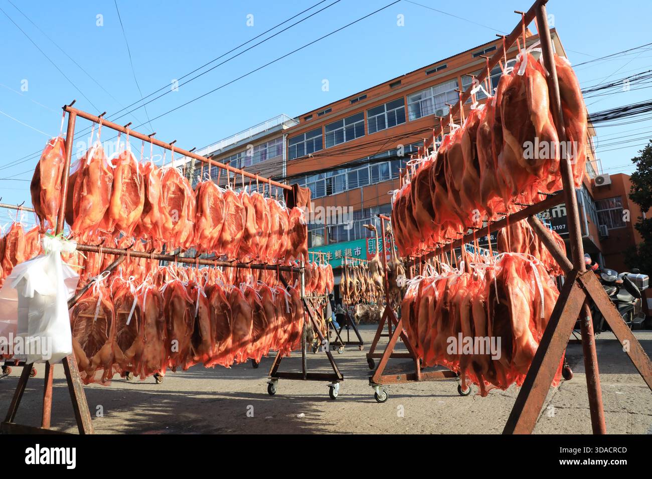 Strings of cured meat are dried in the sun in Jurong City, east China's ...