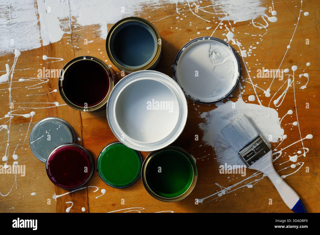 Tin cans with paint on old wooden Stock Photo