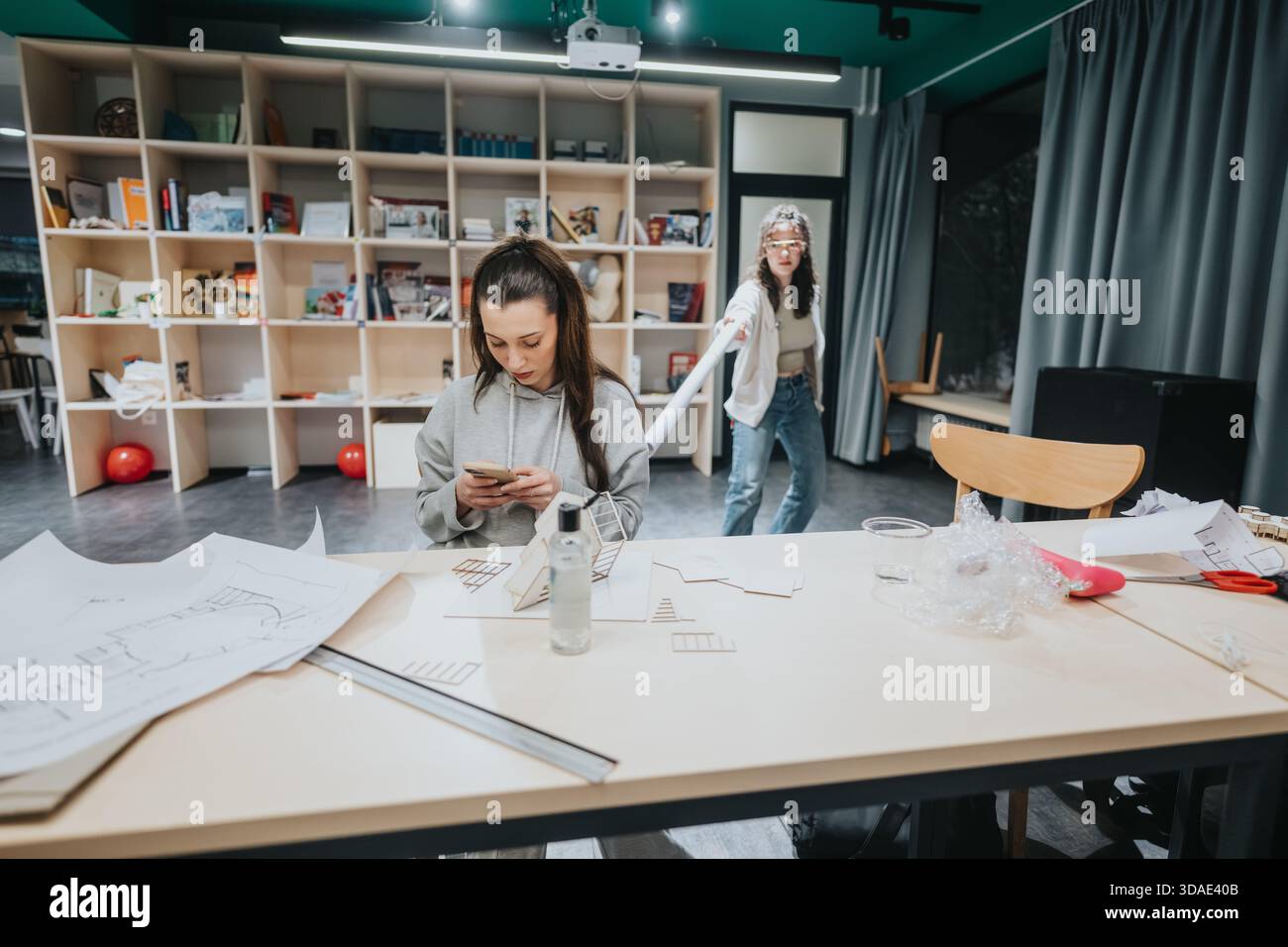 Two Women Collaborating on Creative Projects in a Modern Collaboration Center Studio Stock Photo