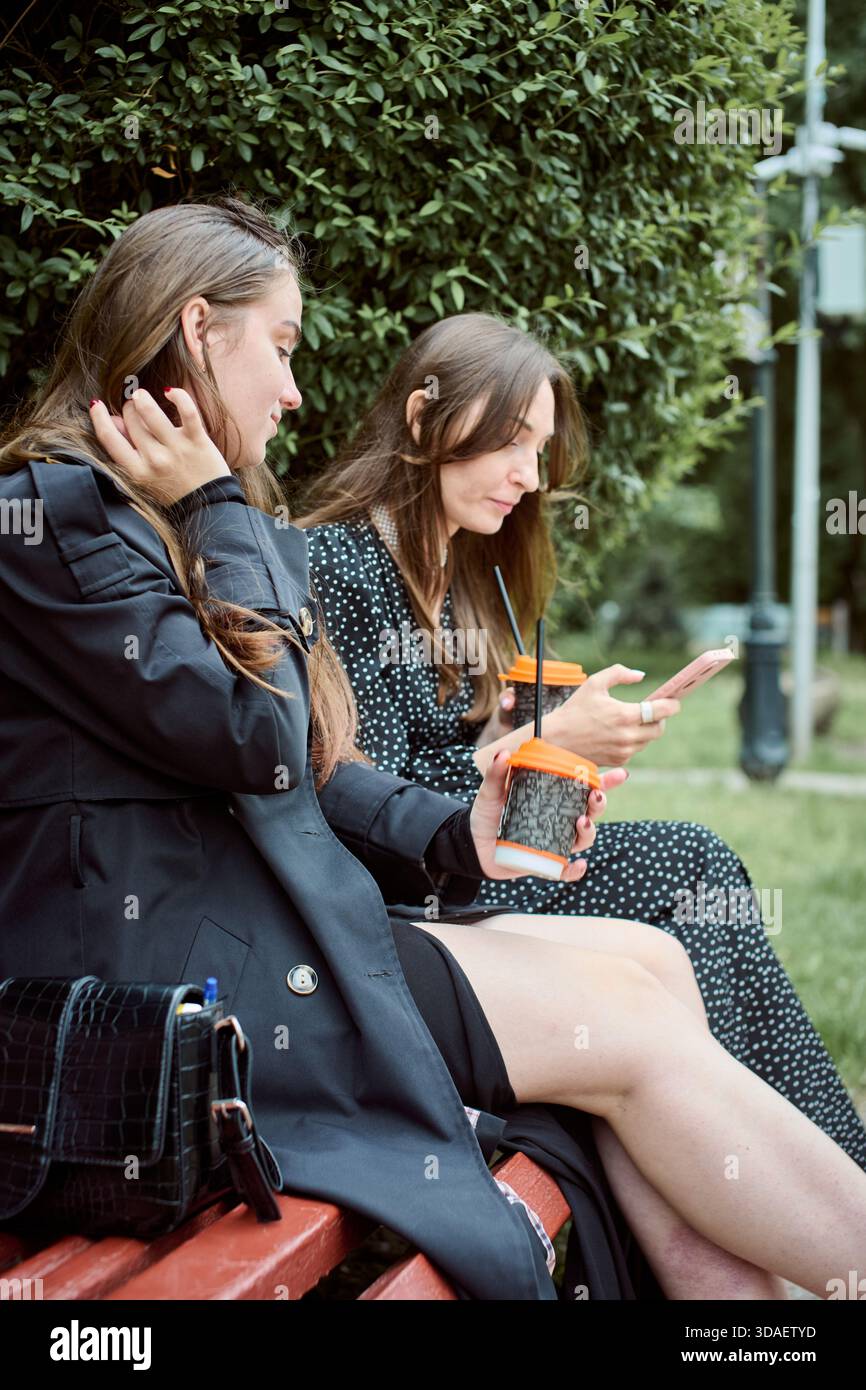 Two women sit closely on hi-res stock photography and images - Alamy