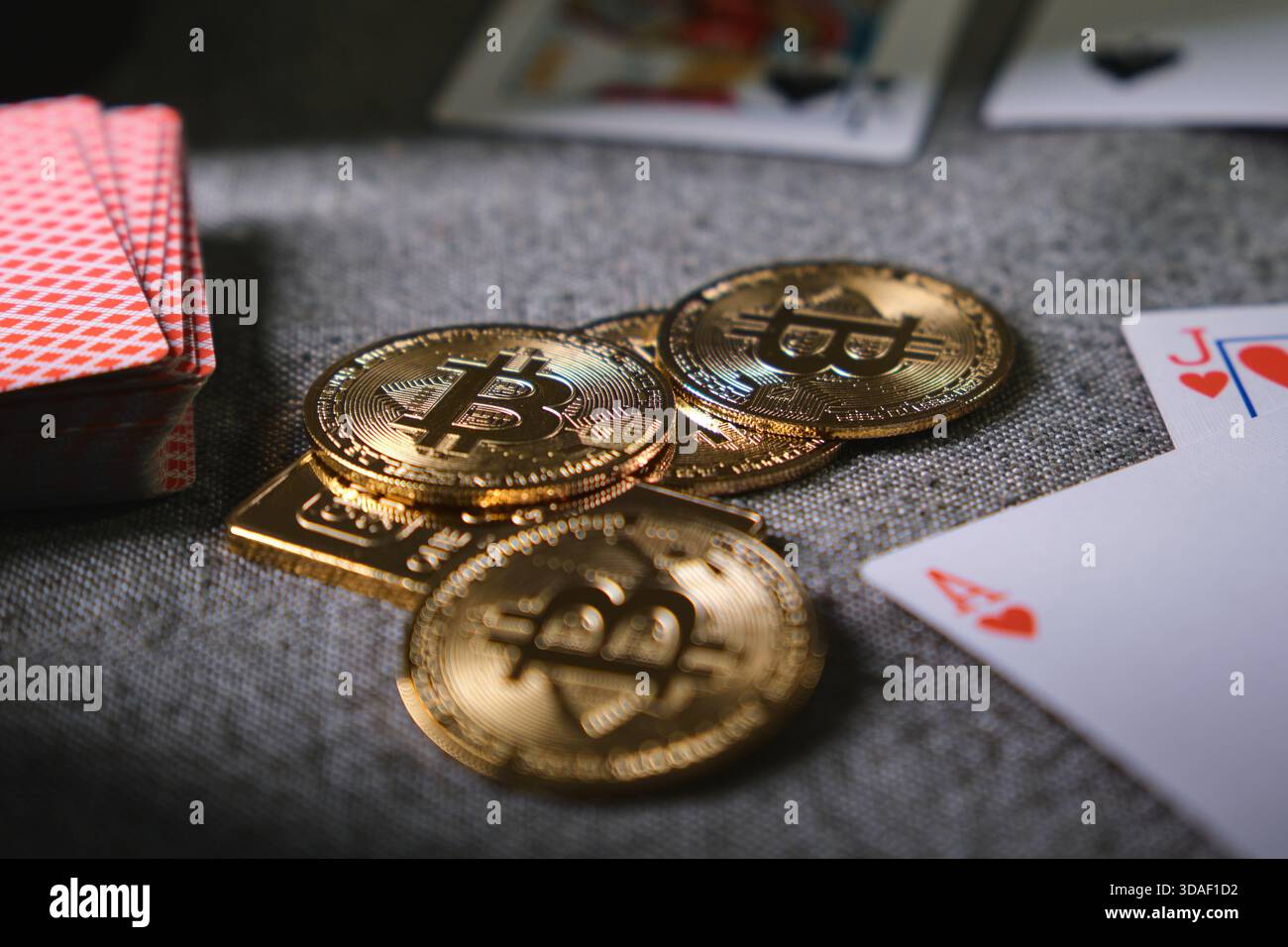 Bitcoin coins stacked on a table with playing cards, symbolizing crypto  gambling risk Stock Photo - Alamy