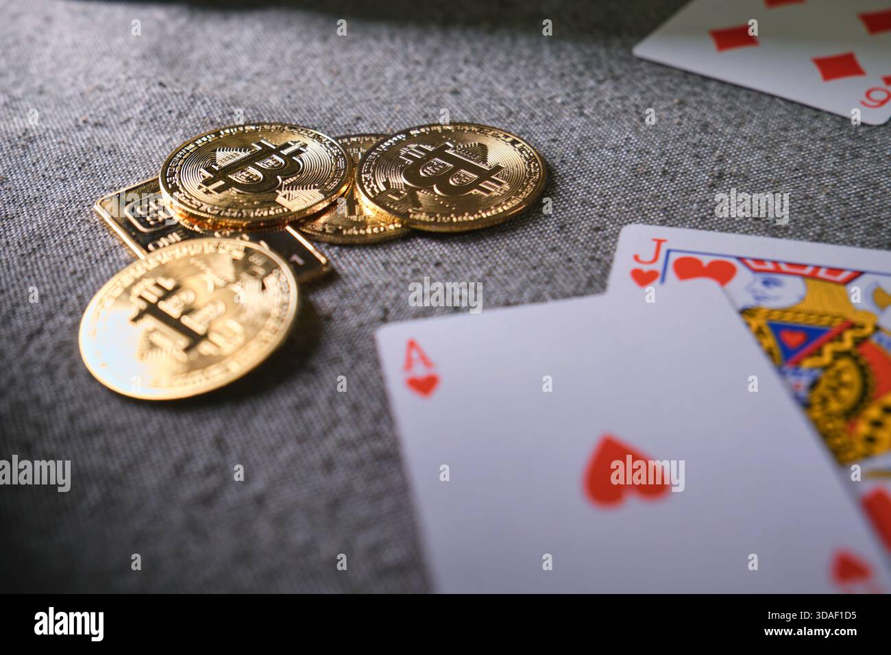 Bitcoin cryptocurrency coins and casino playing cards on a gray fabric  surface Stock Photo - Alamy