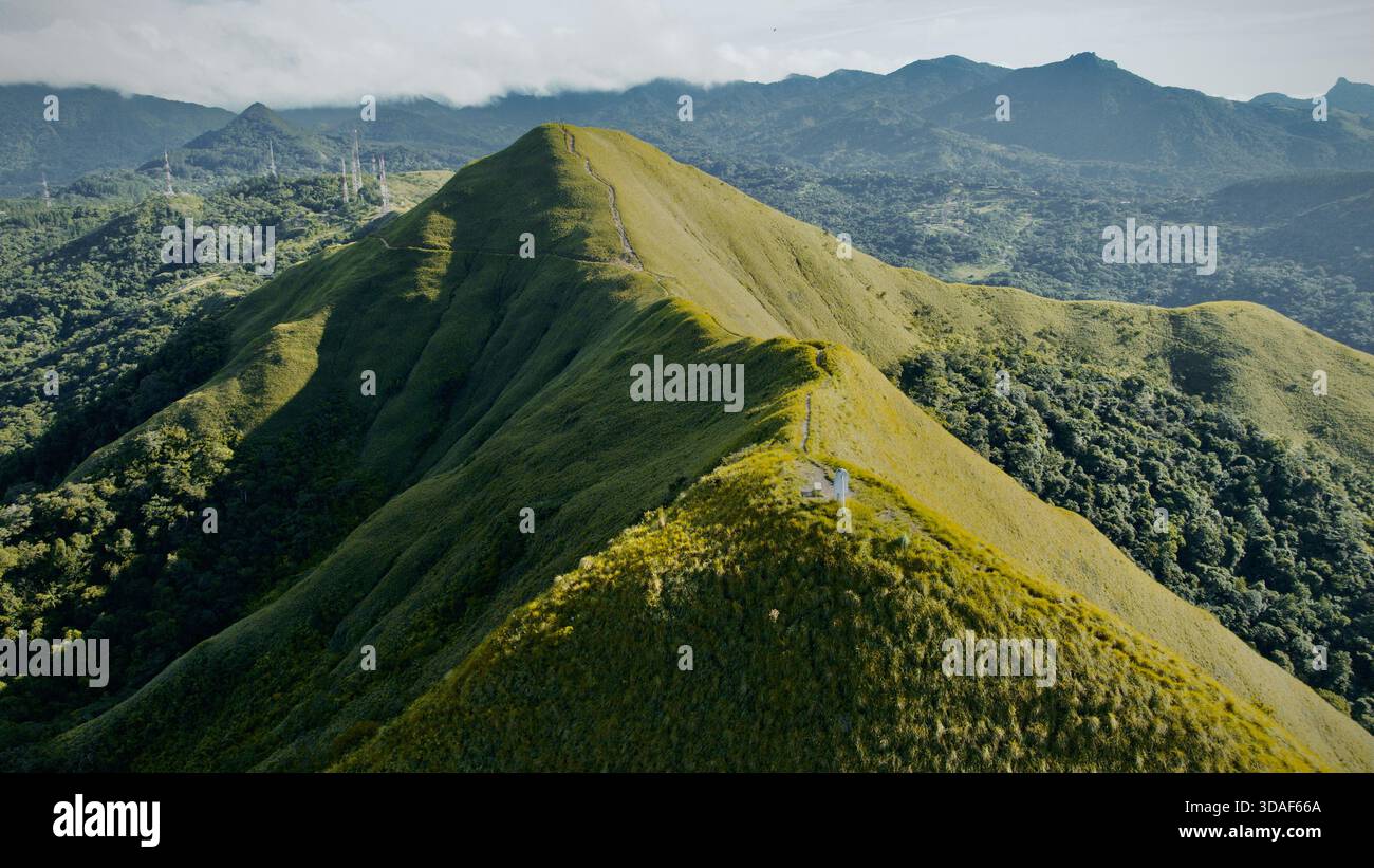 Aerial view of sunlight kissing the grassy ridge as it snakes toward ...