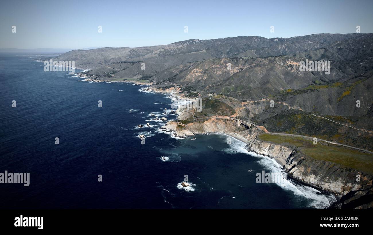 Aerial view of the iconic Bixby Creek Bridge clinging to the rugged ...
