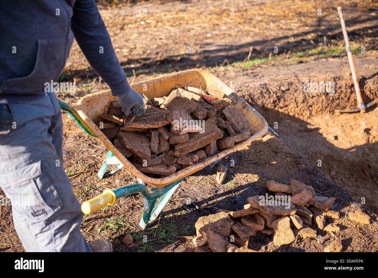 Cleaning an excavation or construction site, hard work. Stock Photo
