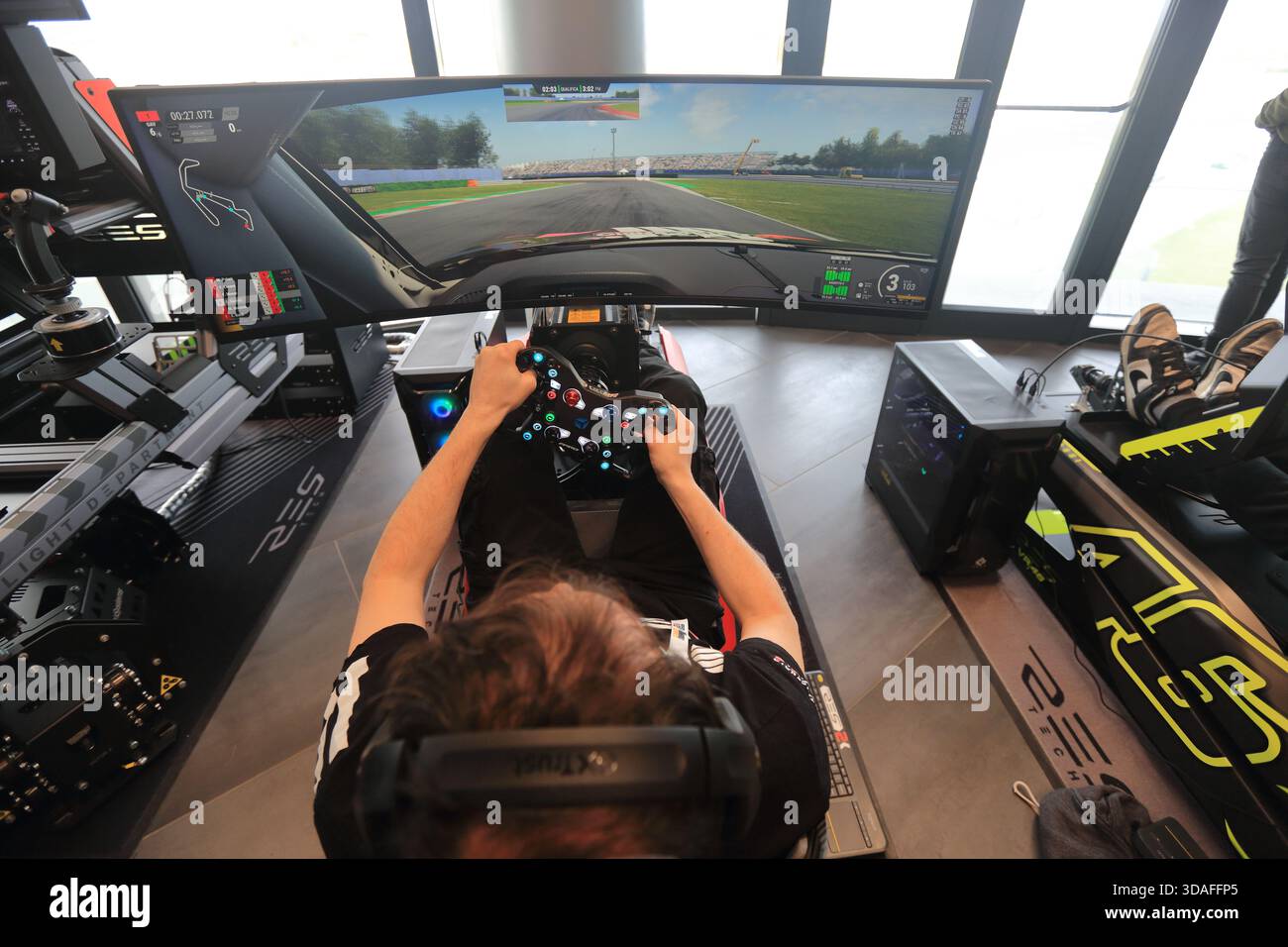 Players participate in a race in the racing car driving simulator at the Misano World Circuit Marco Simoncelli - Stock Image