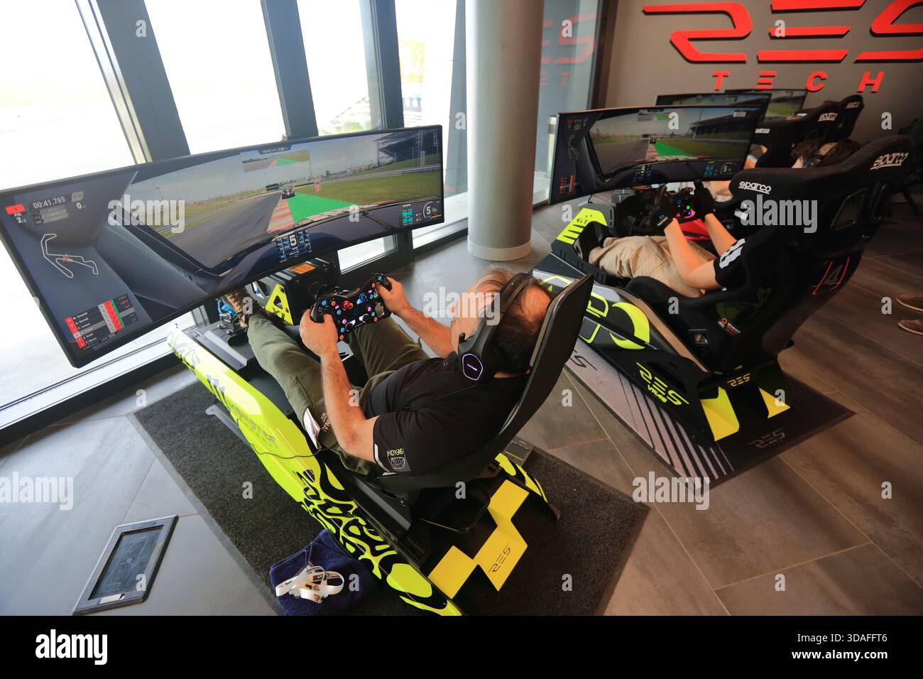 Players participate in a race in the racing car driving simulator at the Misano World Circuit Marco Simoncelli - Stock Image