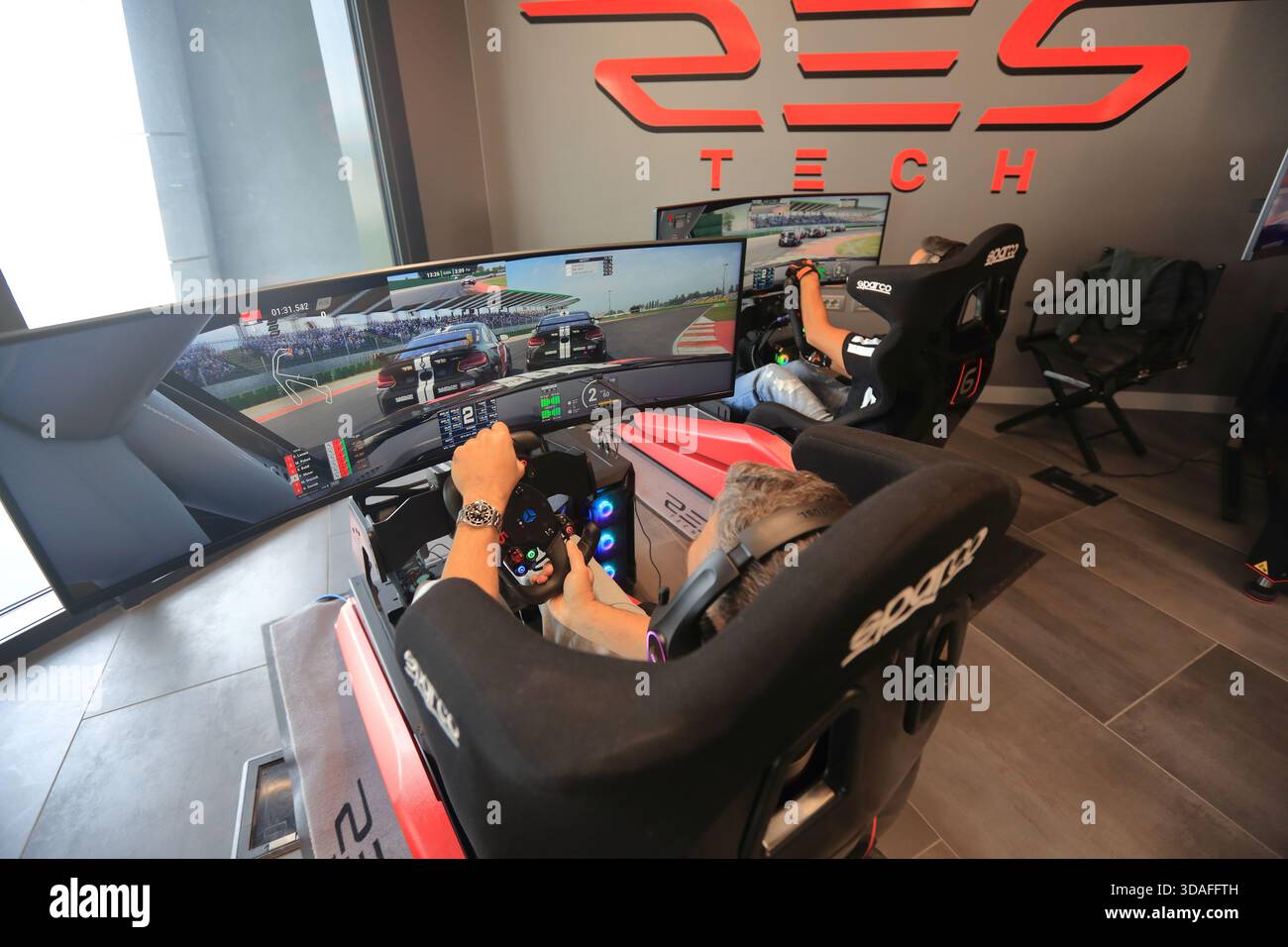 Players participate in a race in the racing car driving simulator at the Misano World Circuit Marco Simoncelli - Stock Image